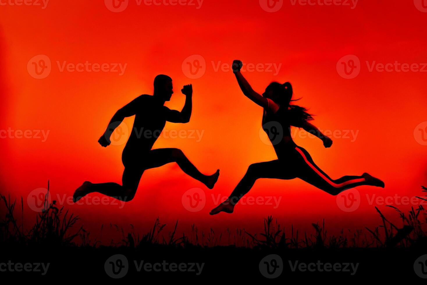 Silhouettes of a sports jumping couple. Concept of gender conflict between a man and a woman photo