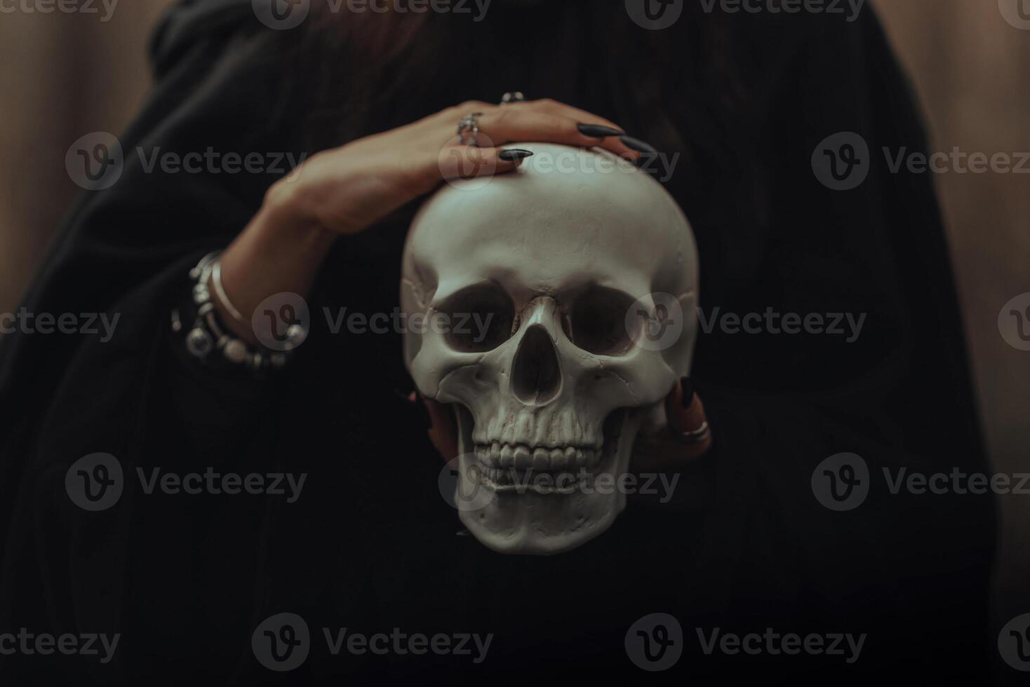 skull of a dead man in the hands of a witch witch photo