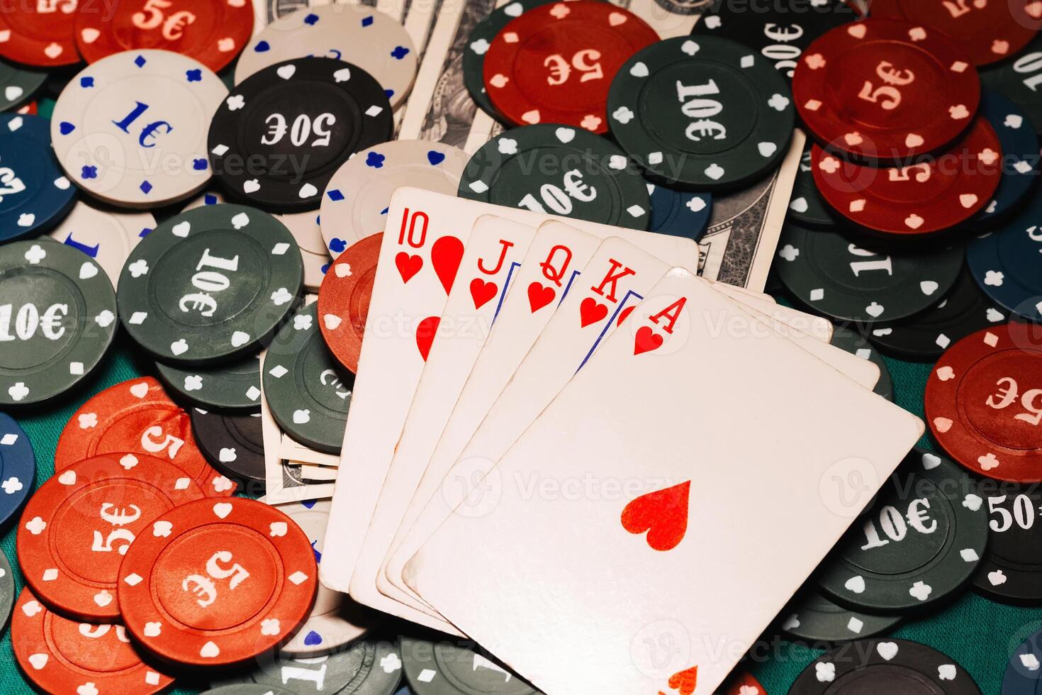 Royal flush in poker on the background of game chips and money dollars photo