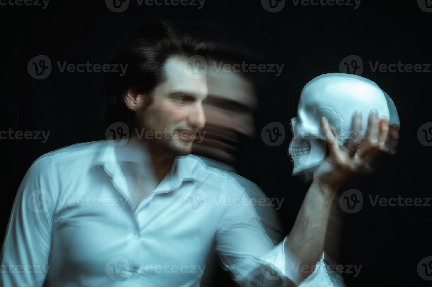 portrait of a psychopathic man with mental disorders with a human skull in hand photo