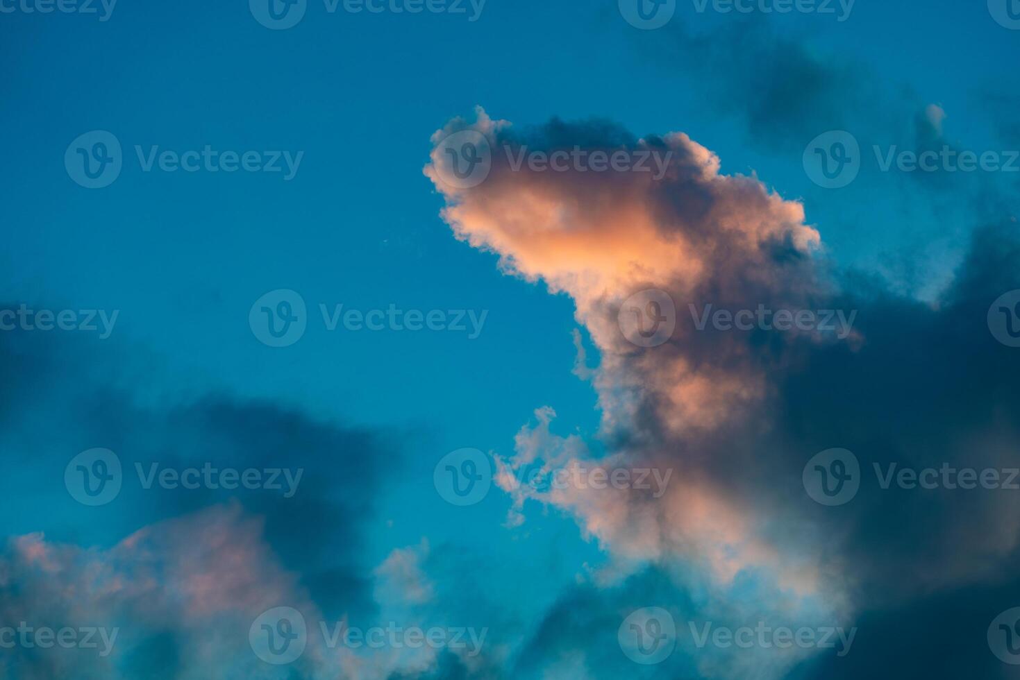 A stunning display of dramatic clouds illuminated by the vibrant colors of a sunset, showcasing the beauty and complexity of nature's evening skies. Perfect for backgrounds and atmospheric scenes. photo