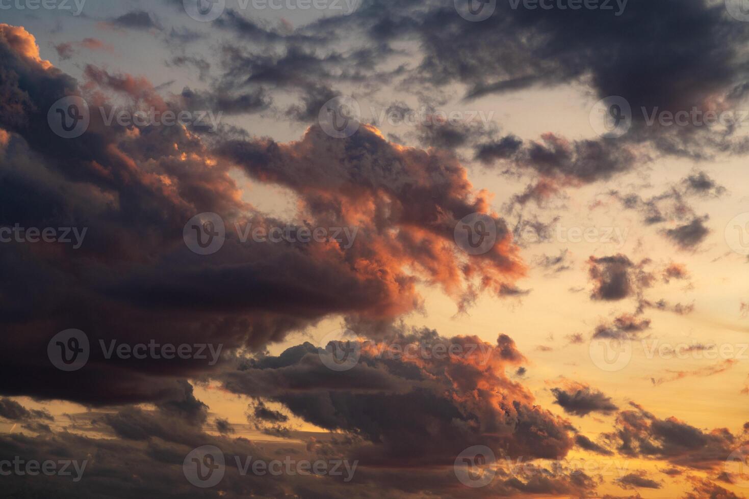 A stunning display of dramatic clouds illuminated by the vibrant colors of a sunset, showcasing the beauty and complexity of nature's evening skies. Perfect for backgrounds and atmospheric scenes. photo