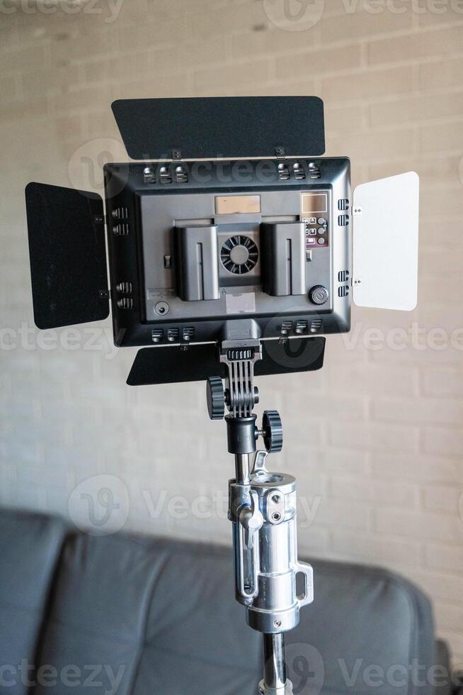 Rear view of a lighting panel mounted on a tripod. LED flashlight,batteries photo
