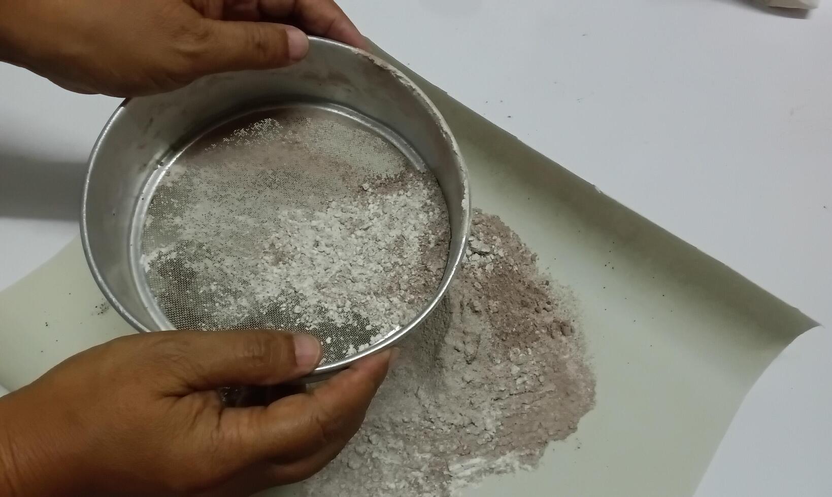 Sift flour and cocoa and use to make dessert photo
