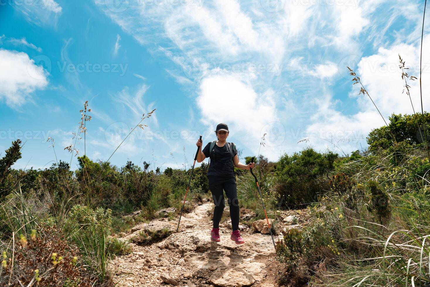 Hiker descending the mountain with enthusiasm, after having walked and contemplated all its beautiful scenery. photo