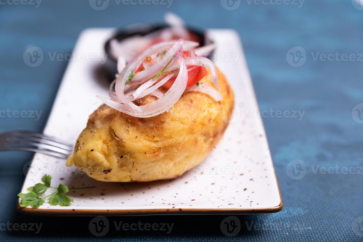 Close-up of crispy potato full of flavor with salad on top. photo