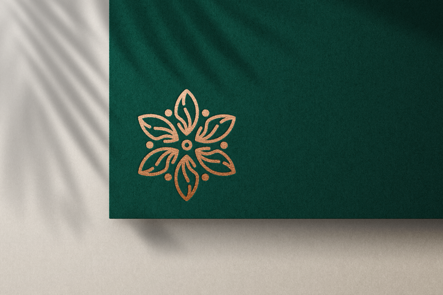 Debossed Logo Mockup with Bronze Foil on Green Paper psd