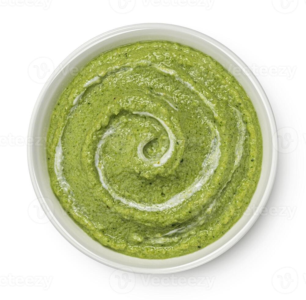 Broccoli soup isolated on white background. Top view photo