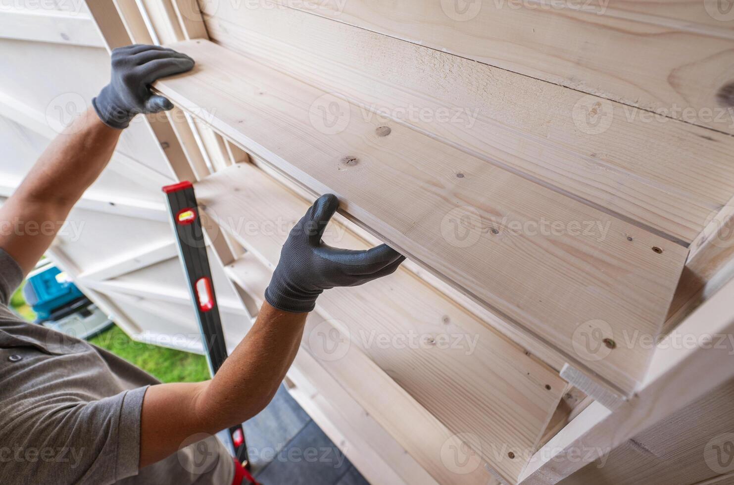 Worker Installing Wooden Shelf photo