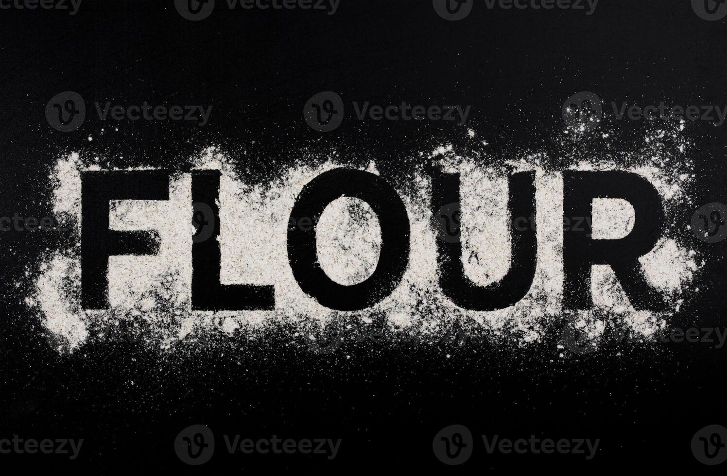 Word flour on dark table photo