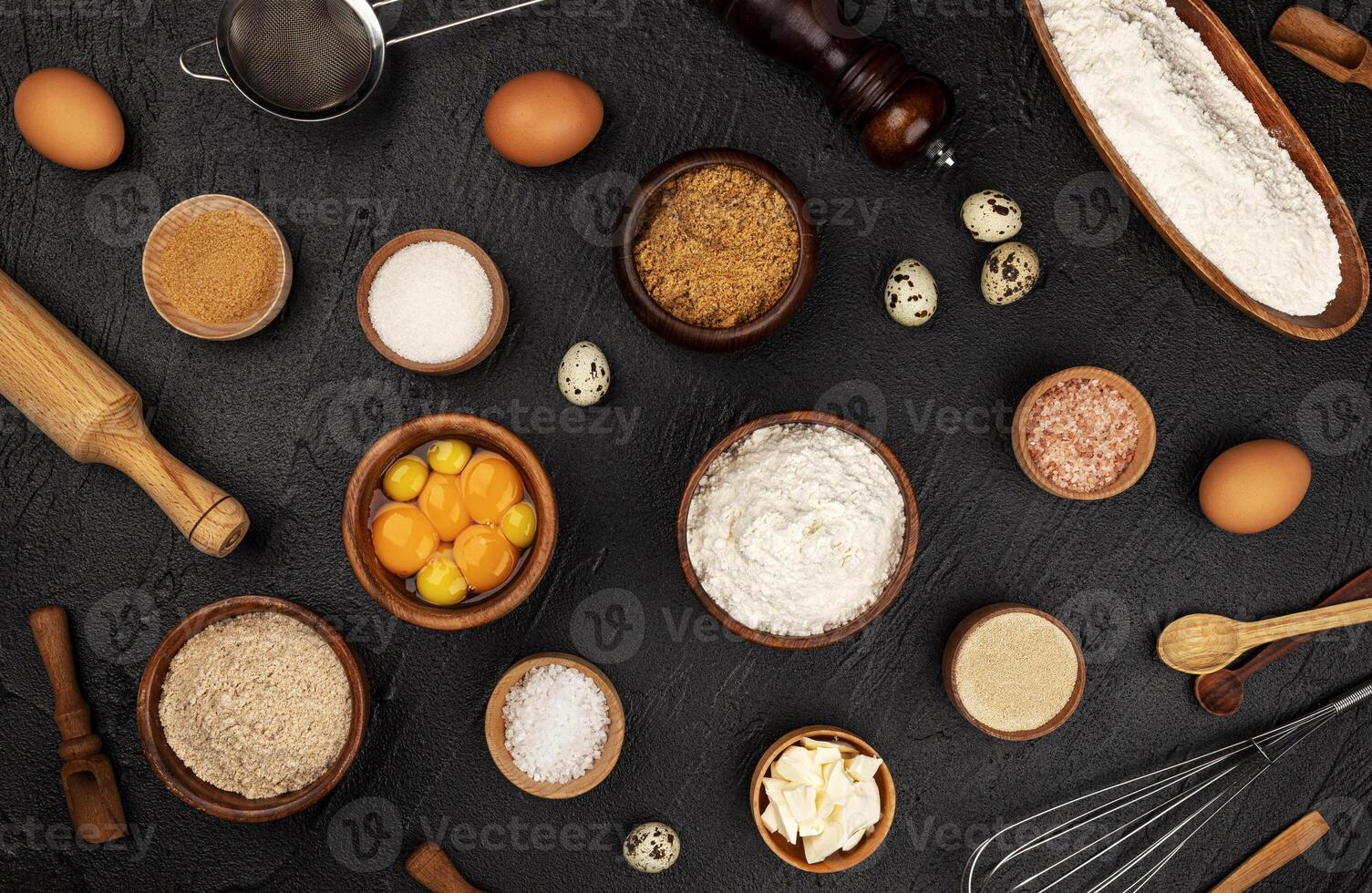 Baking ingredients pattern on black background, top view photo