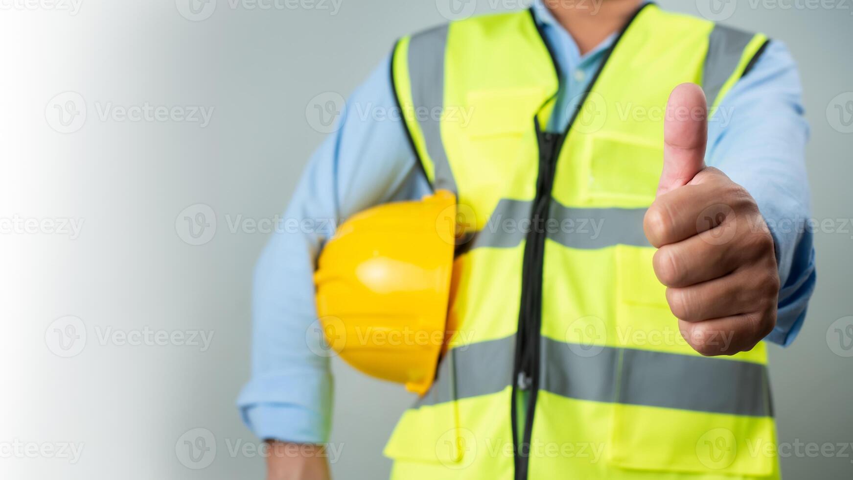 Civil engineer architect standing holding a safety helmet on grey background, Construction site plans to build high-rise buildings, Engineer building concept, Background for construction. photo