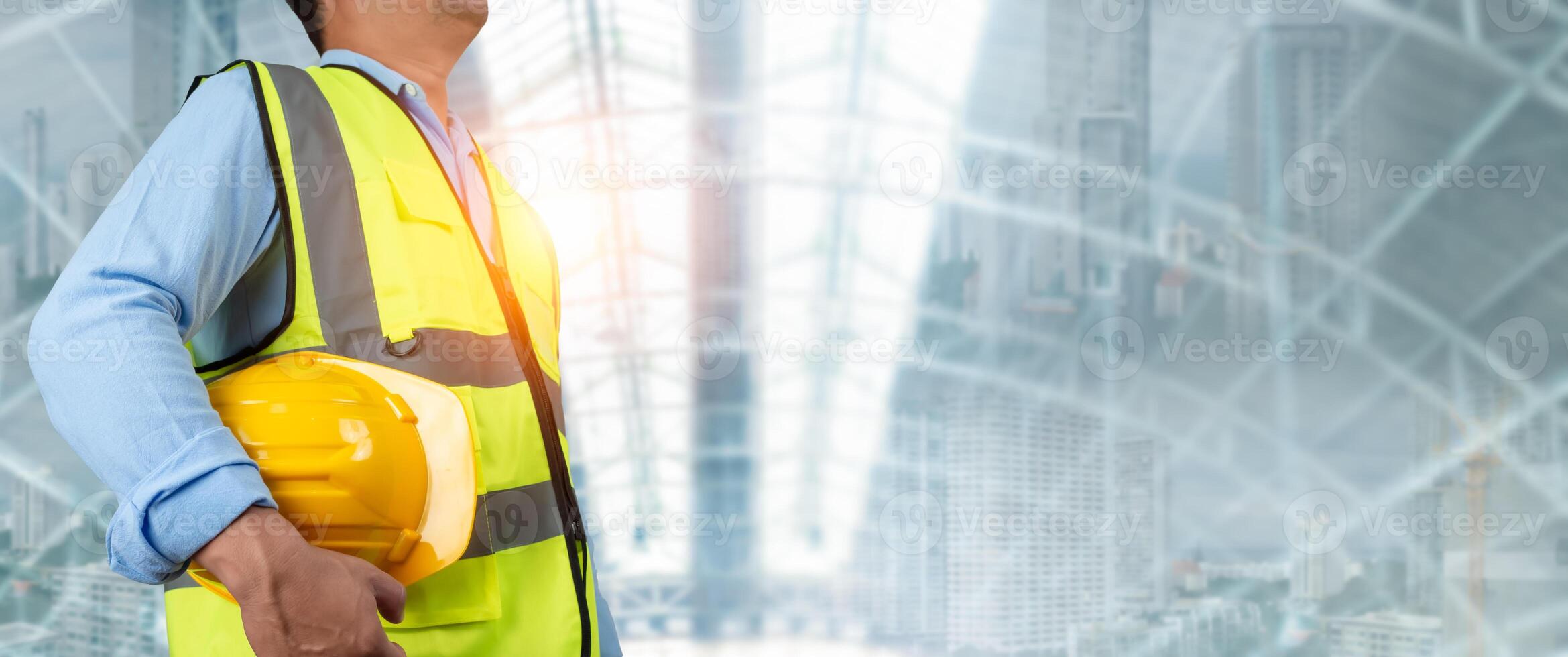 Civil engineer architect standing holding a safety helmet on construction site background, Construction site plans to build high-rise buildings, Engineer building concept, Background for construction. photo