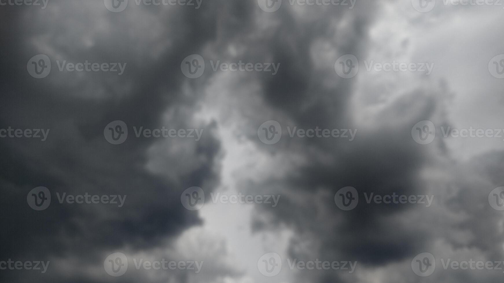 Dark clouds in the sky gather for storms photo