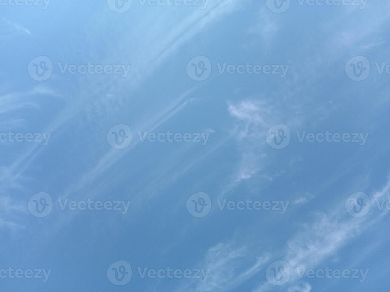 Delicate clouds on a clear blue sky photo