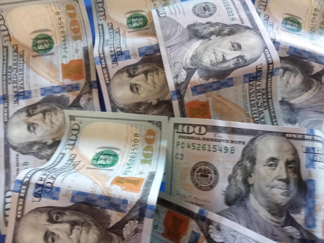 A bunch of dollar bills with different faces on them.Concept of wealth and prosperity background photo
