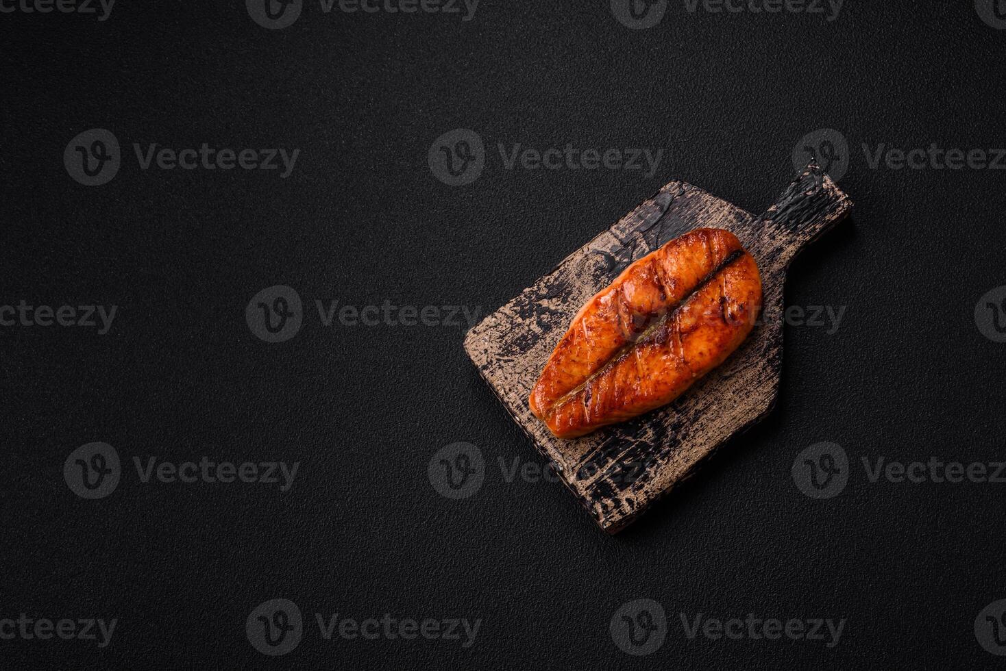 Fresh cooked delicious salmon steak with spices and herbs photo