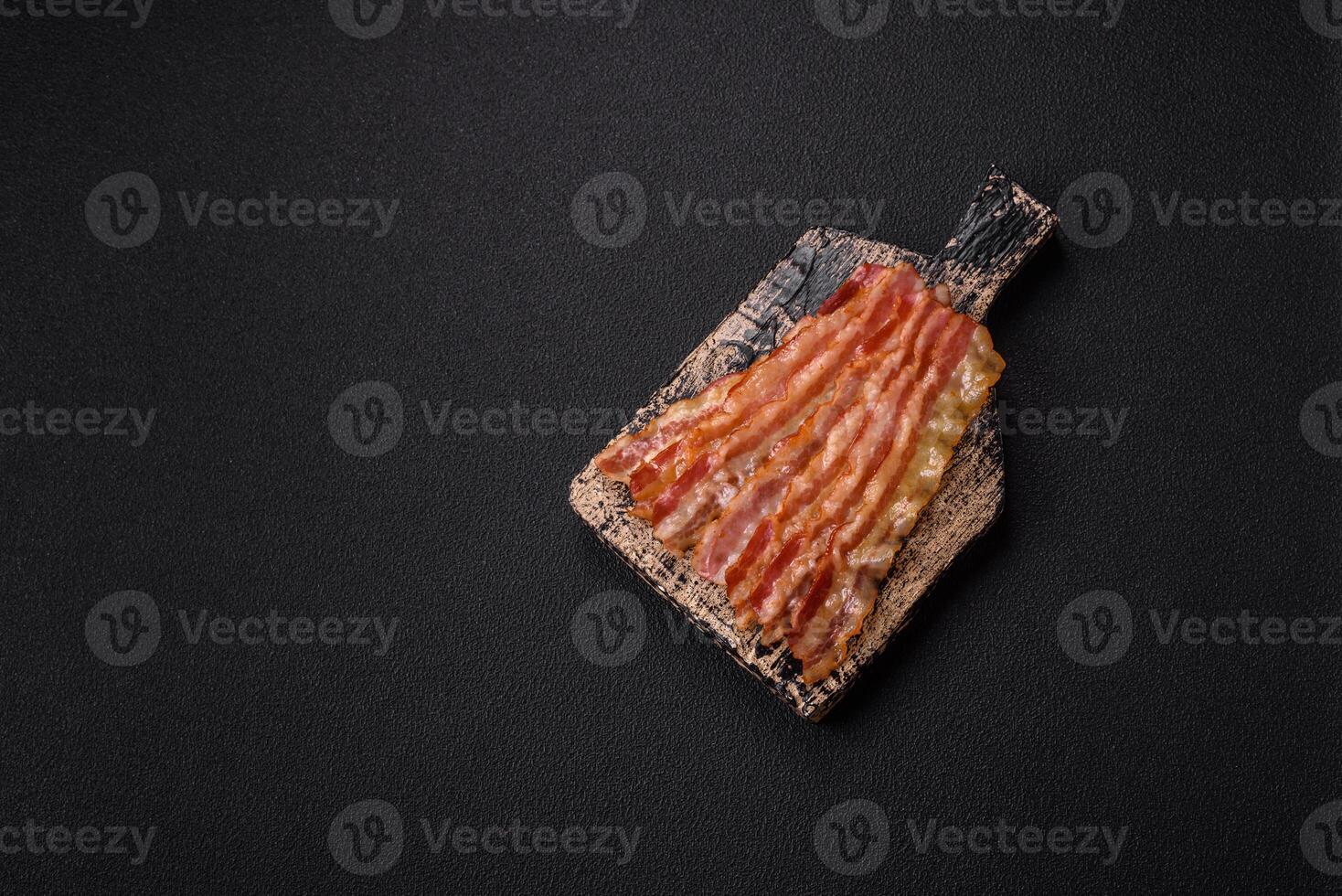 Delicious bacon in the form of slices with salt, spices and herbs photo
