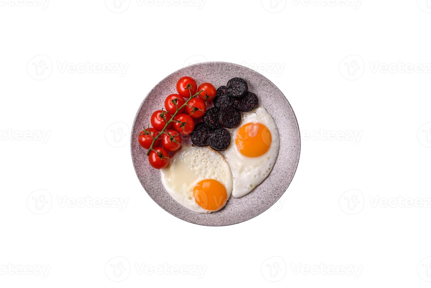 English breakfast with fried eggs, bacon, beans, tomatoes, spices and herbs photo