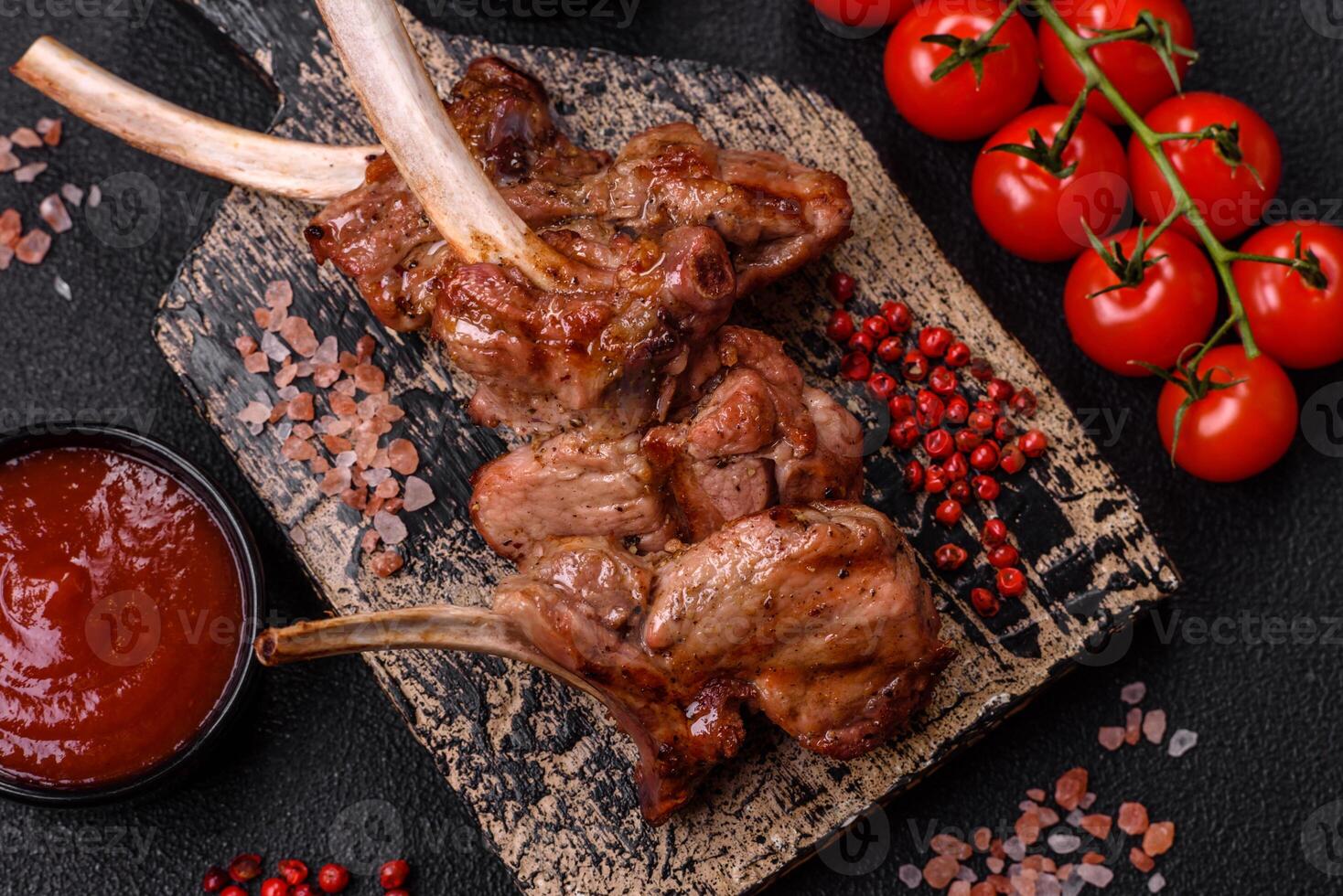 Delicious juicy meat on the bone or rack of lamb or grilled veal photo
