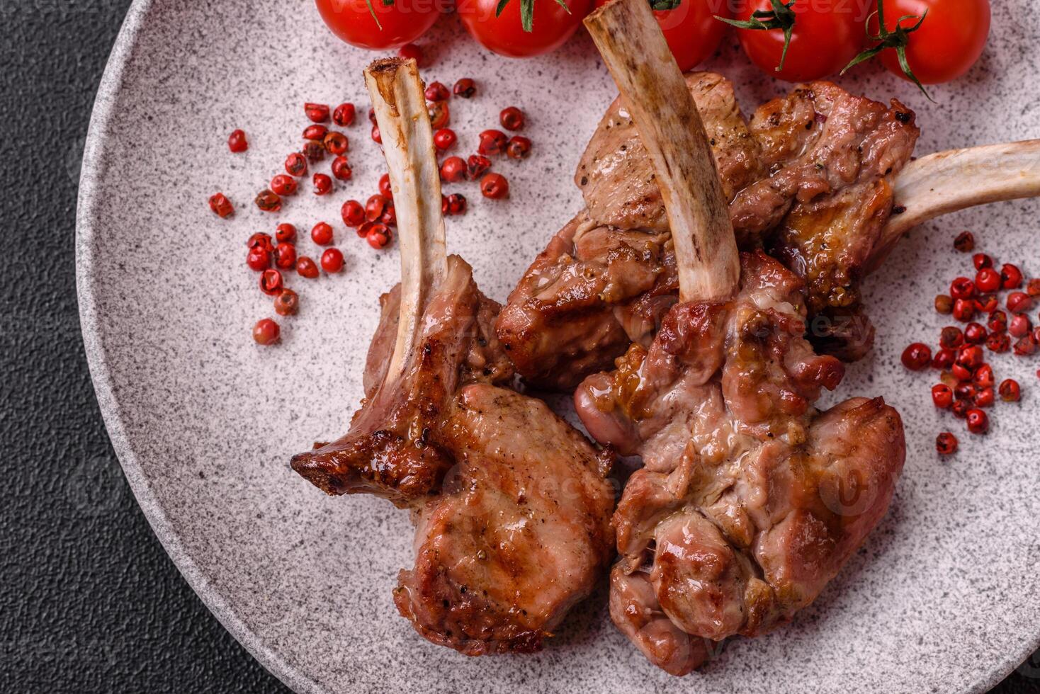 Delicious juicy meat on the bone or rack of lamb or grilled veal photo