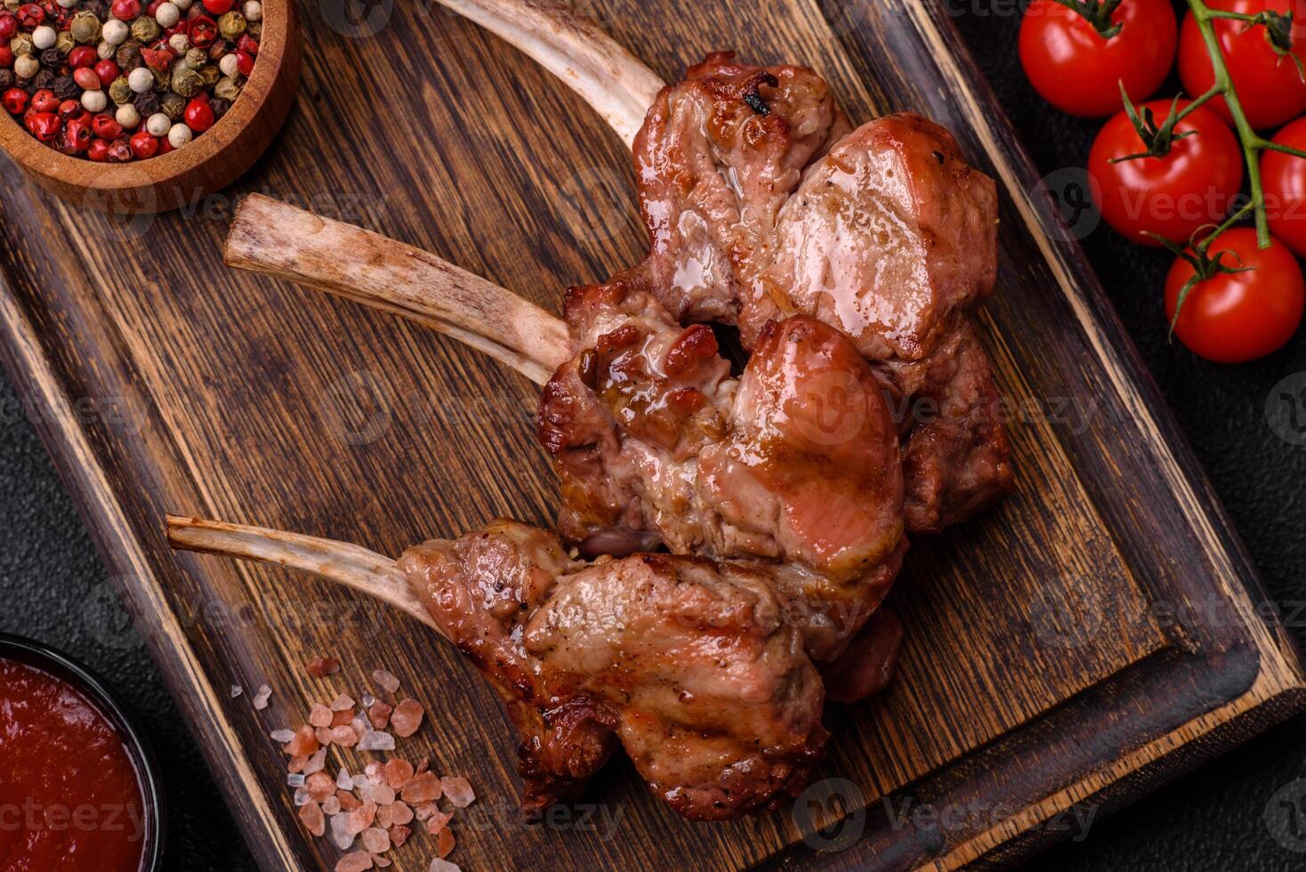 Delicious juicy meat on the bone or rack of lamb or grilled veal photo