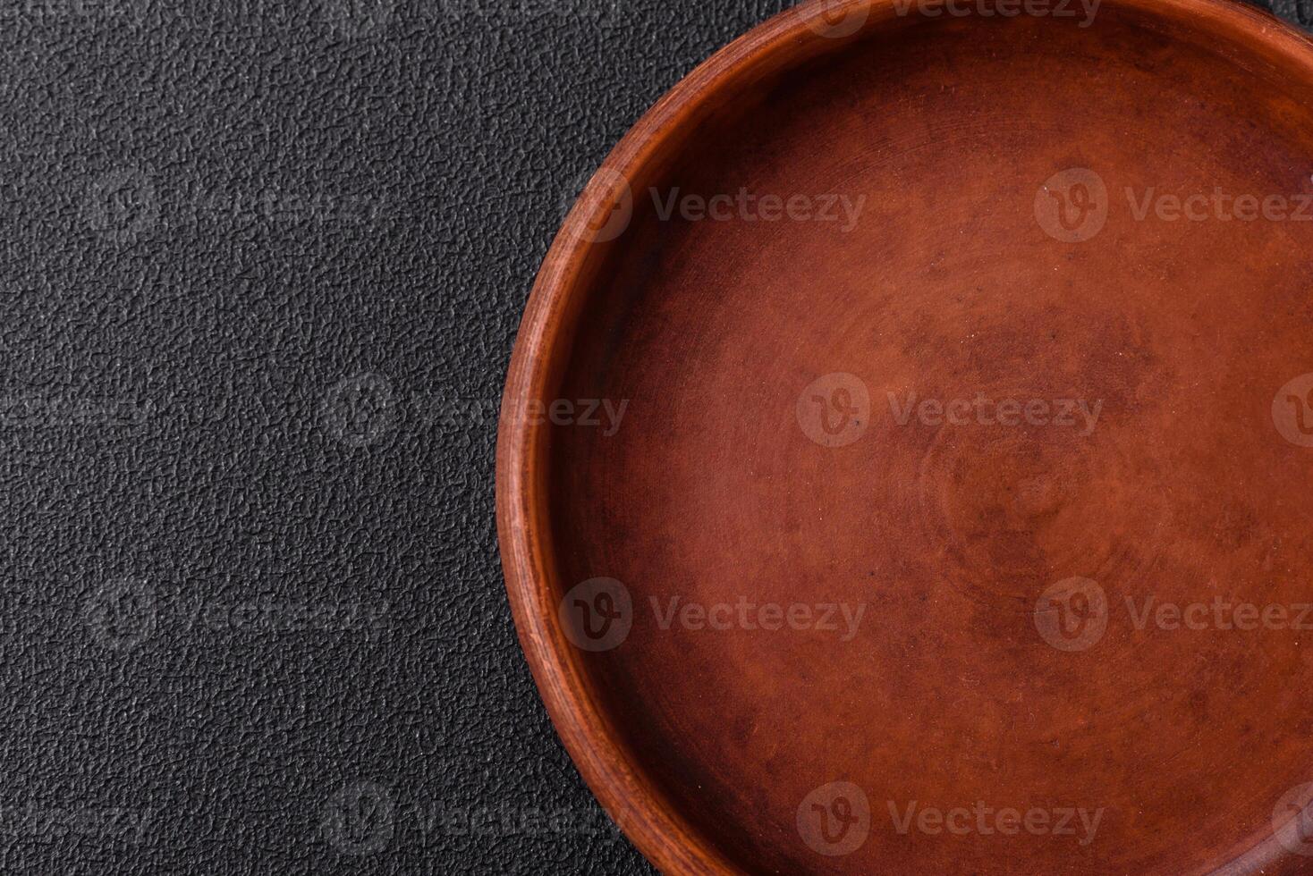 Empty ceramic round plate on dark textured concrete background photo