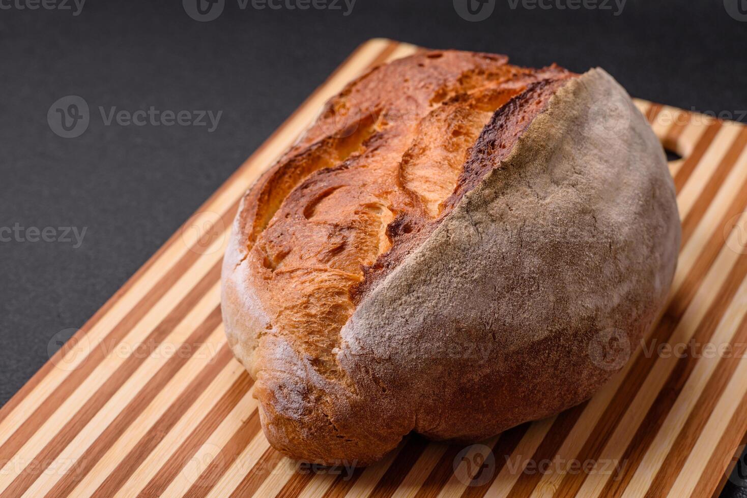 A loaf of brown bread with grains of cereals photo