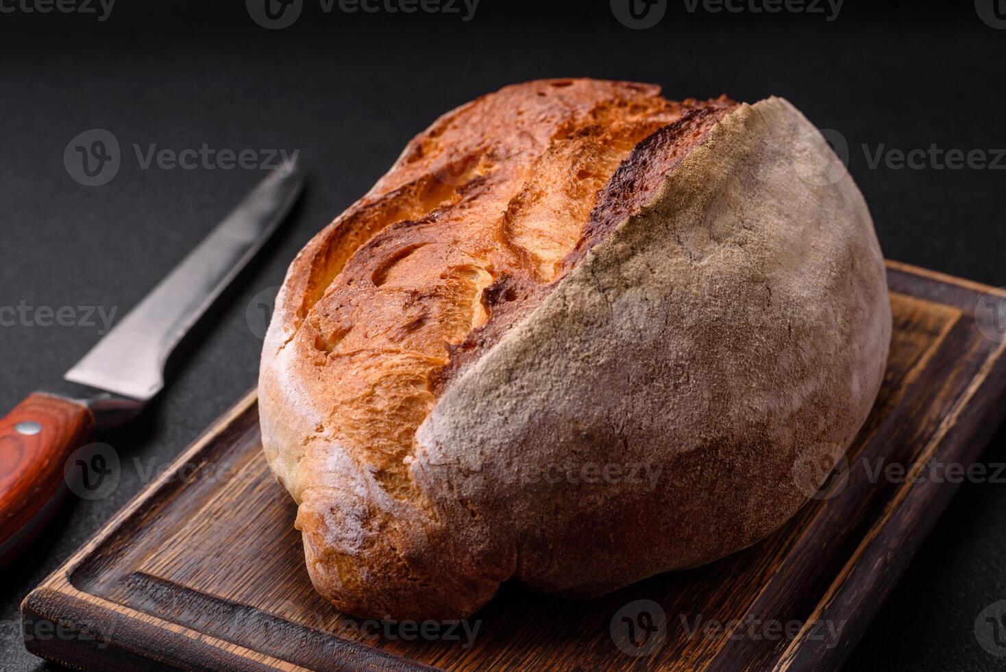 A loaf of brown bread with grains of cereals photo