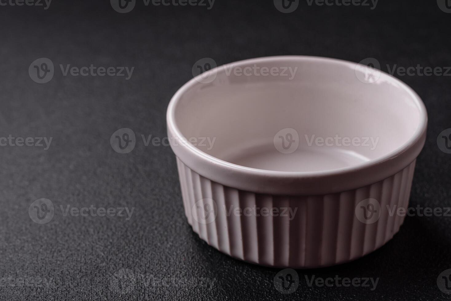 Beautiful empty white ceramic gravy boat on a concrete background photo