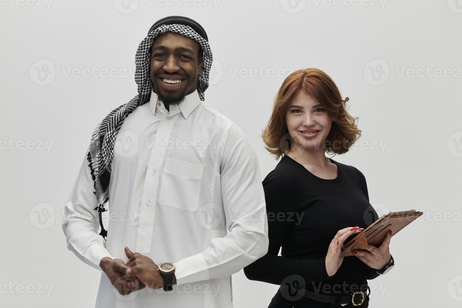 Arabic entrepreneur and a businesswoman, exuding confidence and unity, pose together against a clean white backdrop, symbolizing a dynamic partnership characterized by ambition, innovation, and photo