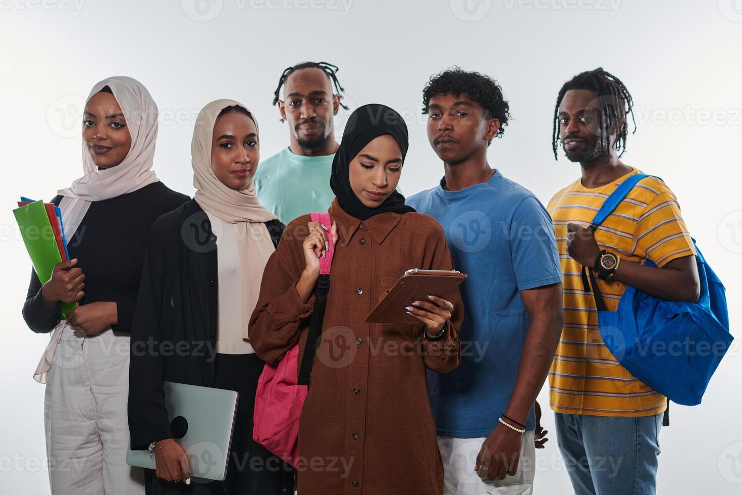 Group of diverse students engages in modern educational practices, utilizing a variety of technological tools such as laptops, tablets, and smartphones against a clean white background, exemplifying photo