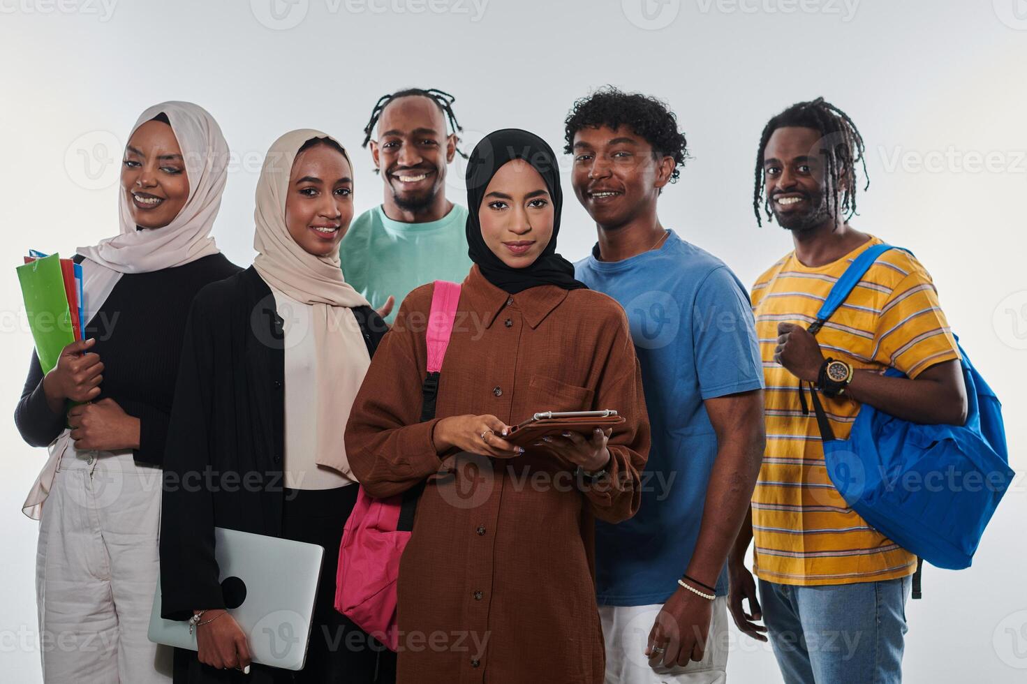 Group of diverse students engages in modern educational practices, utilizing a variety of technological tools such as laptops, tablets, and smartphones against a clean white background, exemplifying photo