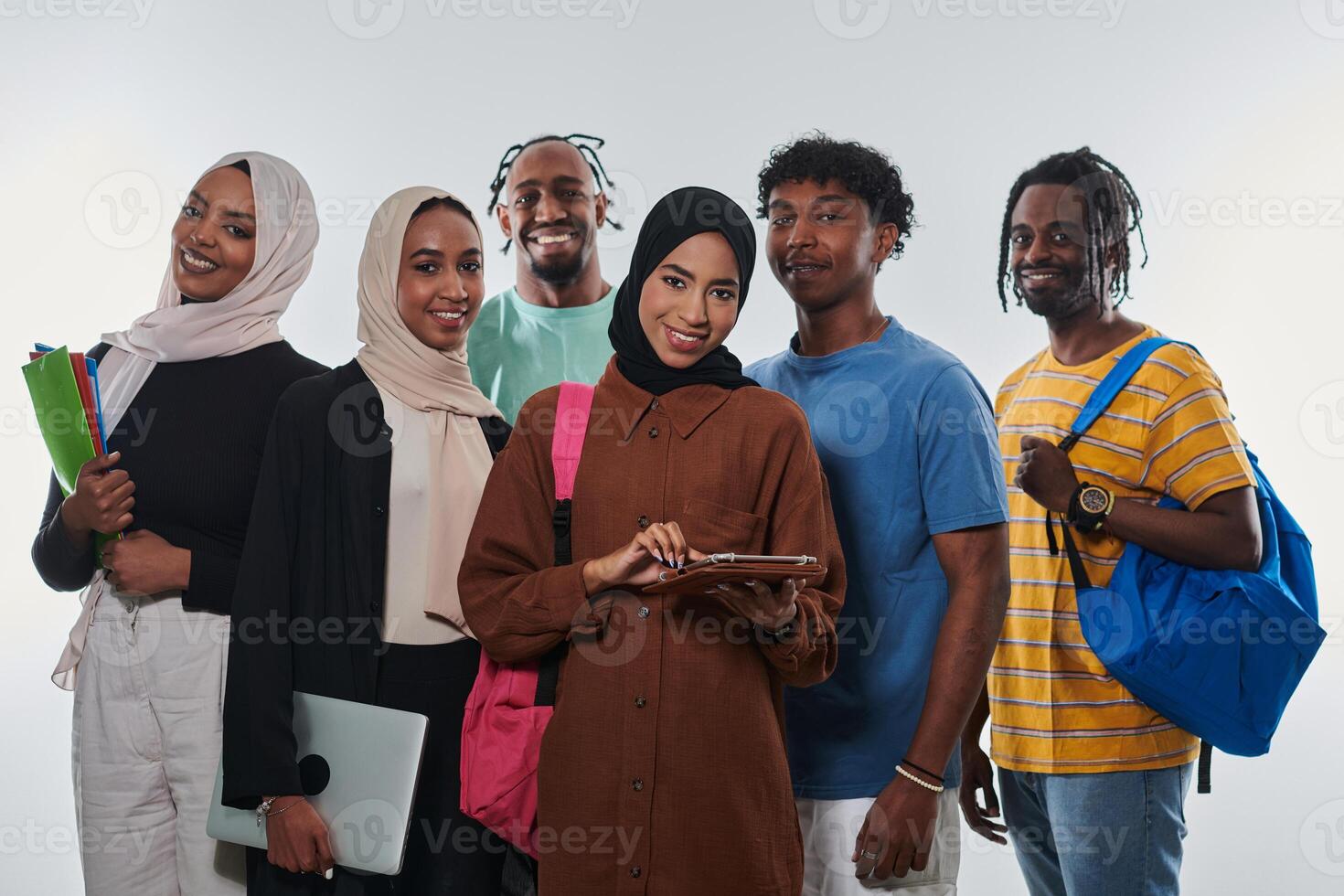 Group of diverse students engages in modern educational practices, utilizing a variety of technological tools such as laptops, tablets, and smartphones against a clean white background, exemplifying photo