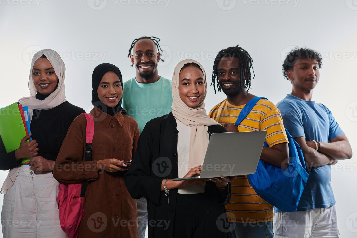 Group of diverse students engages in modern educational practices, utilizing a variety of technological tools such as laptops, tablets, and smartphones against a clean white background, exemplifying photo