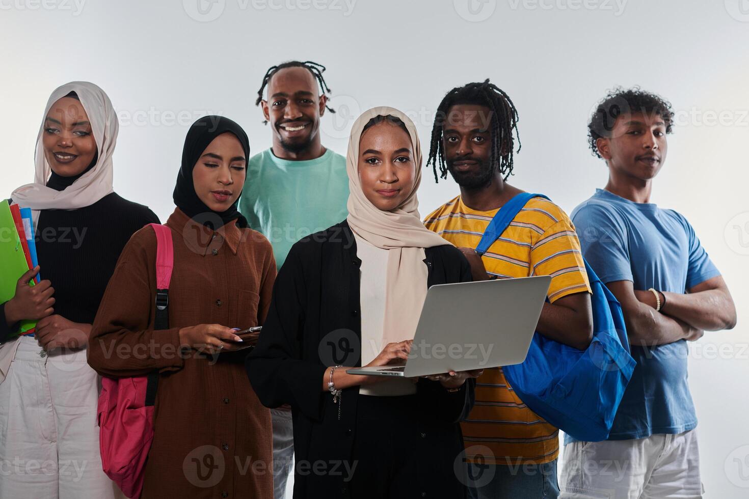 Group of diverse students engages in modern educational practices, utilizing a variety of technological tools such as laptops, tablets, and smartphones against a clean white background, exemplifying photo