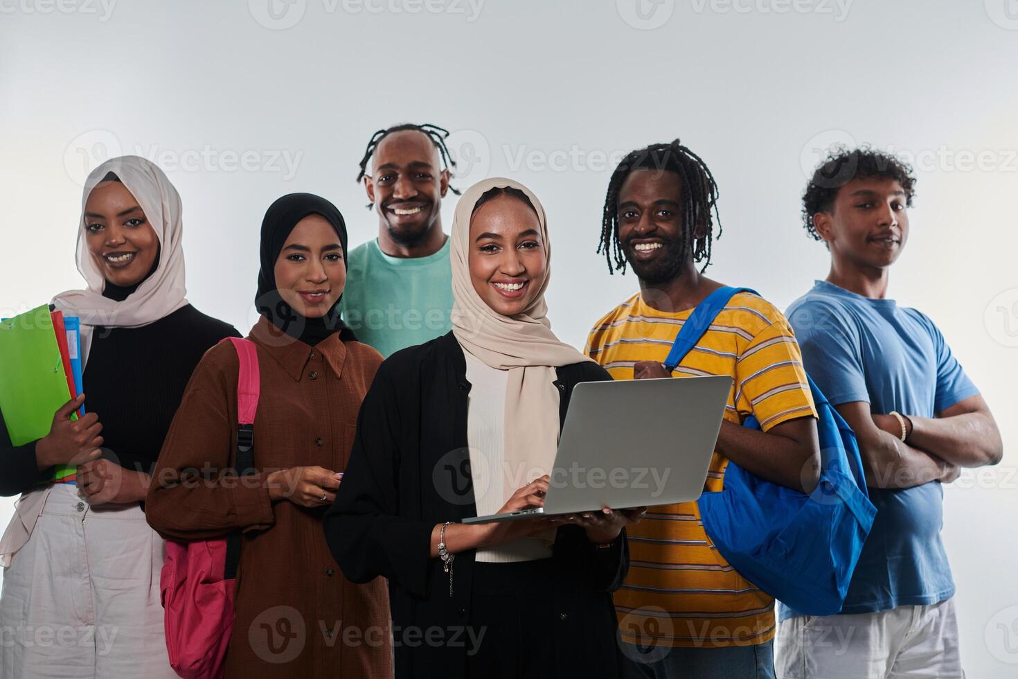 Group of diverse students engages in modern educational practices, utilizing a variety of technological tools such as laptops, tablets, and smartphones against a clean white background, exemplifying photo