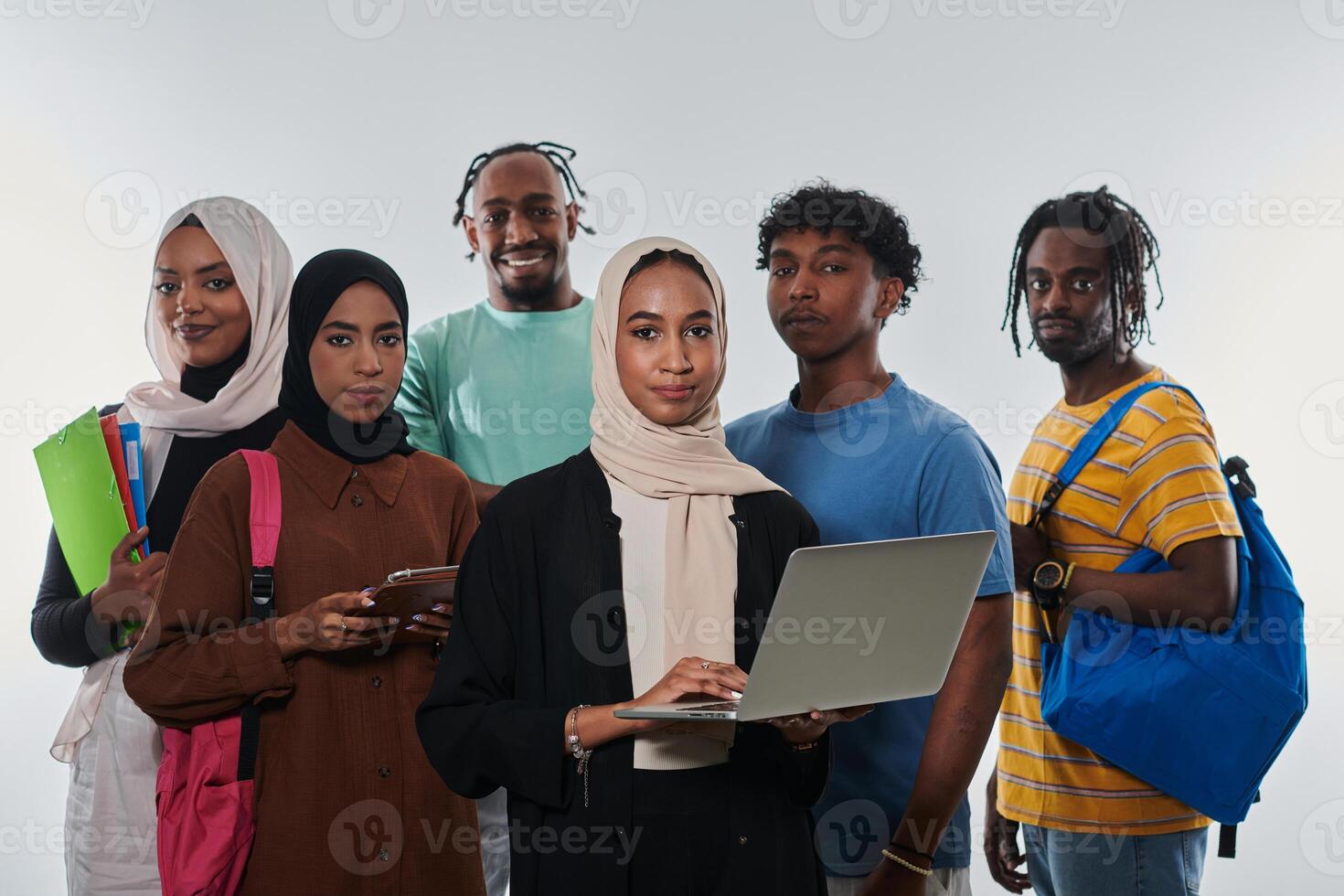 Group of diverse students engages in modern educational practices, utilizing a variety of technological tools such as laptops, tablets, and smartphones against a clean white background, exemplifying photo