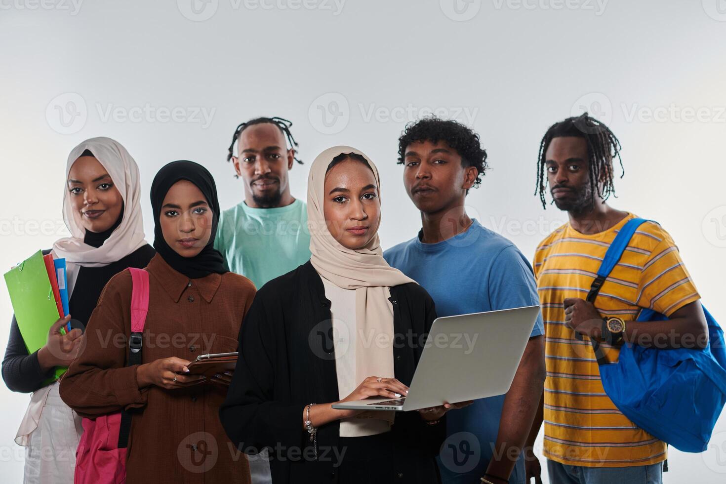 Group of diverse students engages in modern educational practices, utilizing a variety of technological tools such as laptops, tablets, and smartphones against a clean white background, exemplifying photo