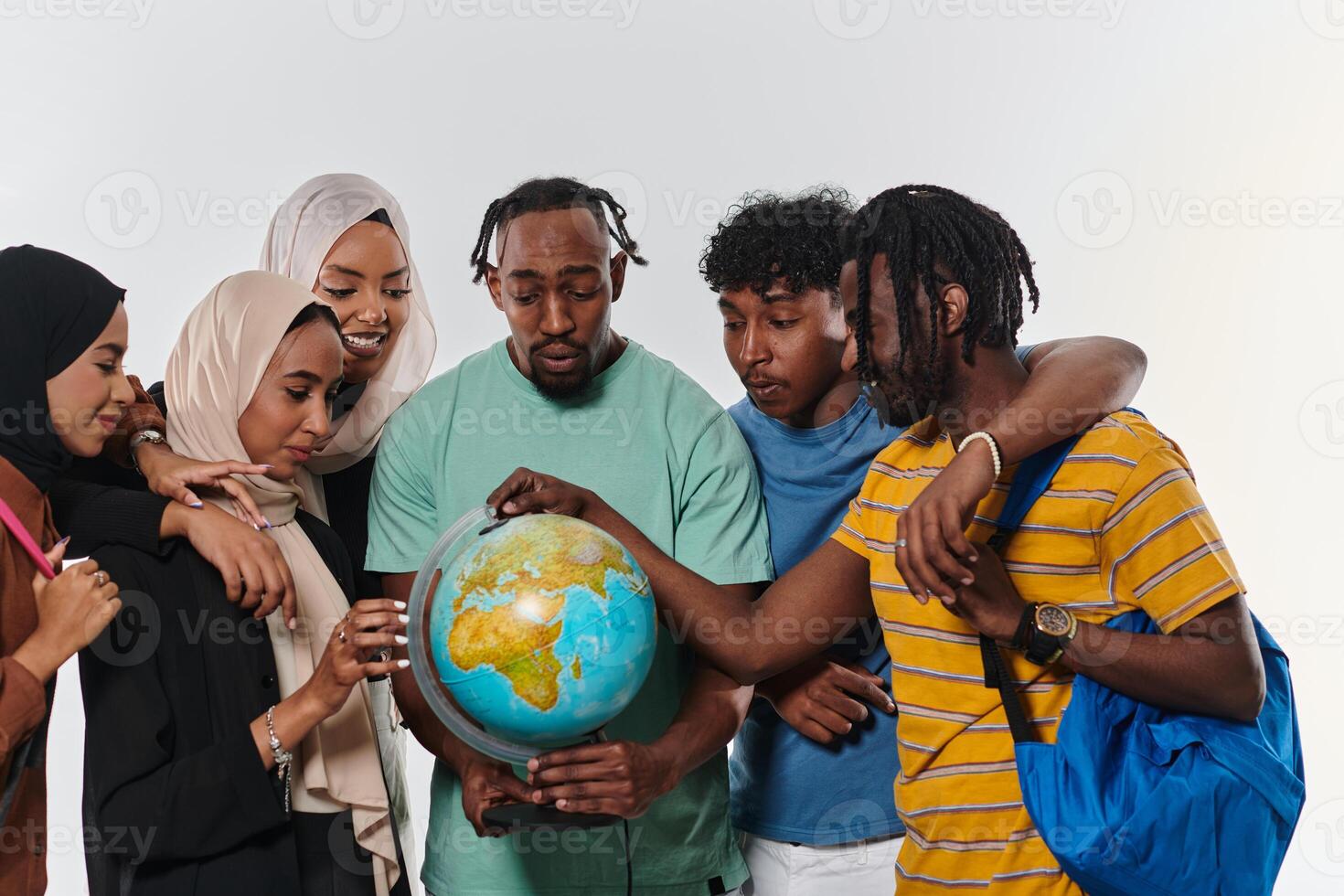 A diverse group of students is gathered around a globe, engrossed in exploration and study, their vibrant energy captured against a pristine white background, symbolizing unity and curiosity in their photo
