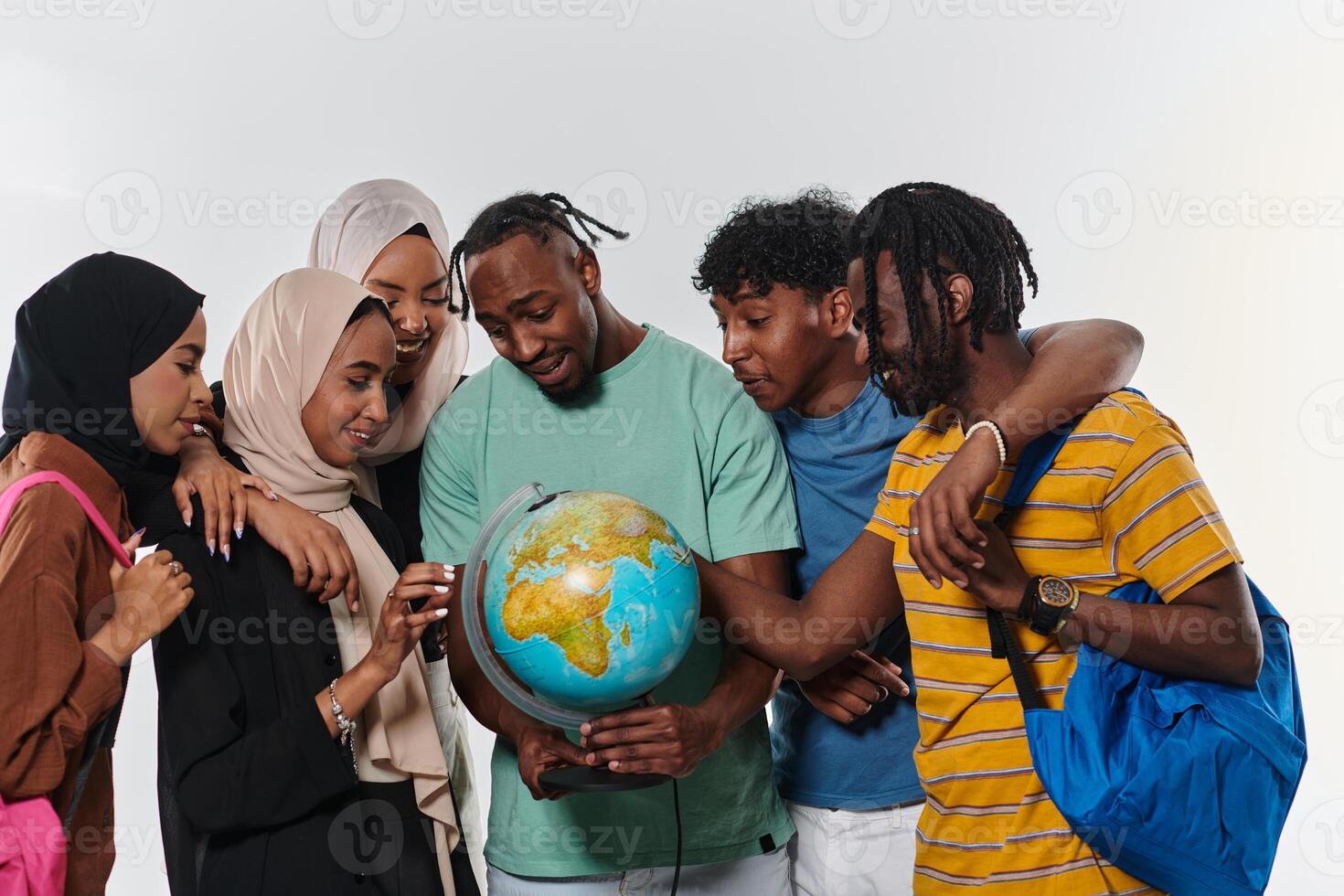 A diverse group of students is gathered around a globe, engrossed in exploration and study, their vibrant energy captured against a pristine white background, symbolizing unity and curiosity in their photo