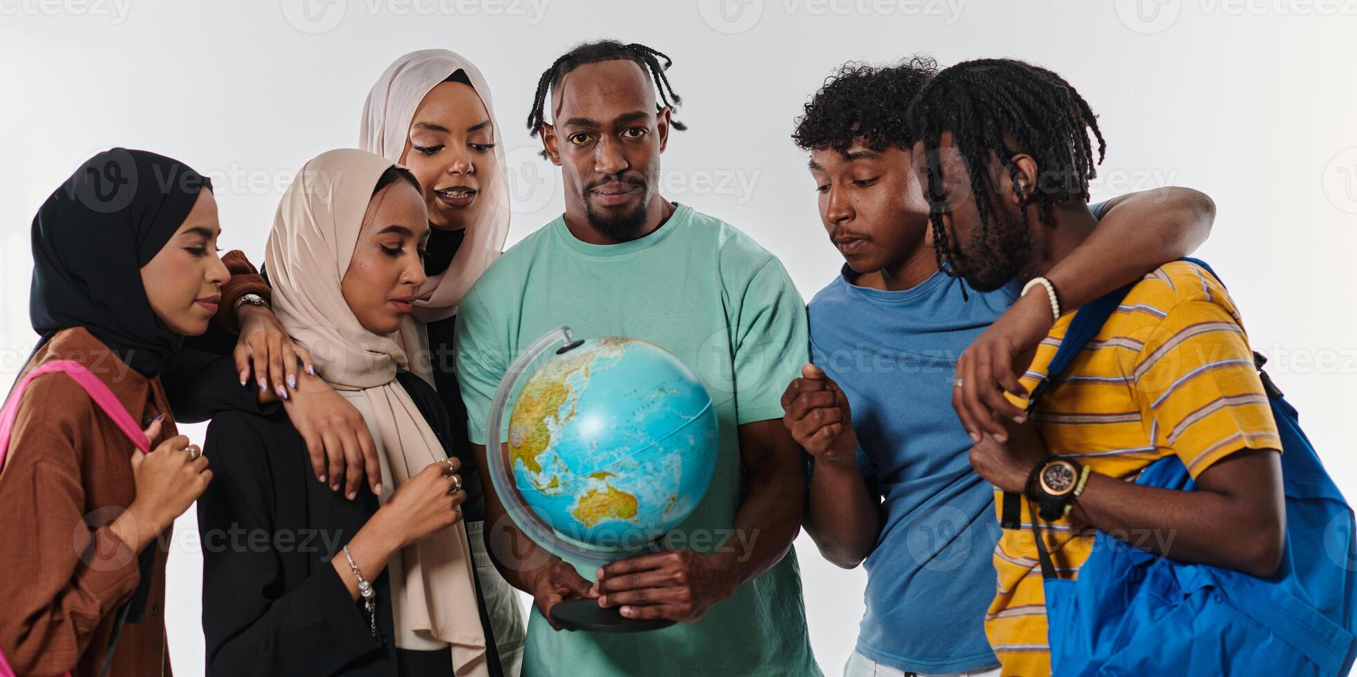 A diverse group of students is gathered around a globe, engrossed in exploration and study, their vibrant energy captured against a pristine white background, symbolizing unity and curiosity in their photo