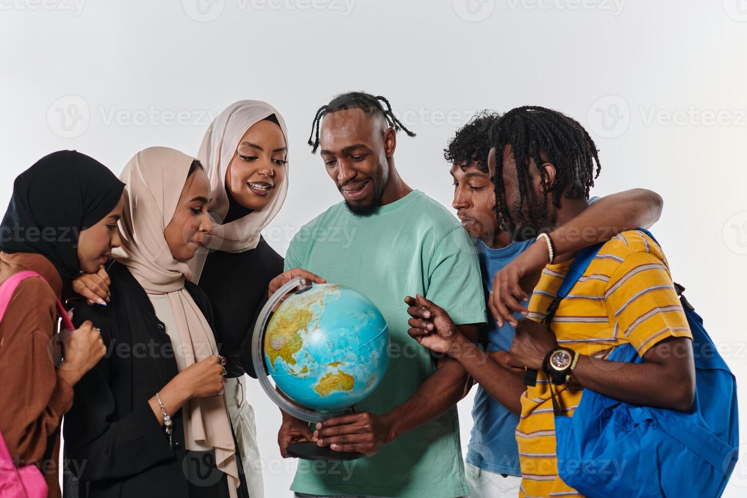 A diverse group of students is gathered around a globe, engrossed in exploration and study, their vibrant energy captured against a pristine white background, symbolizing unity and curiosity in their photo