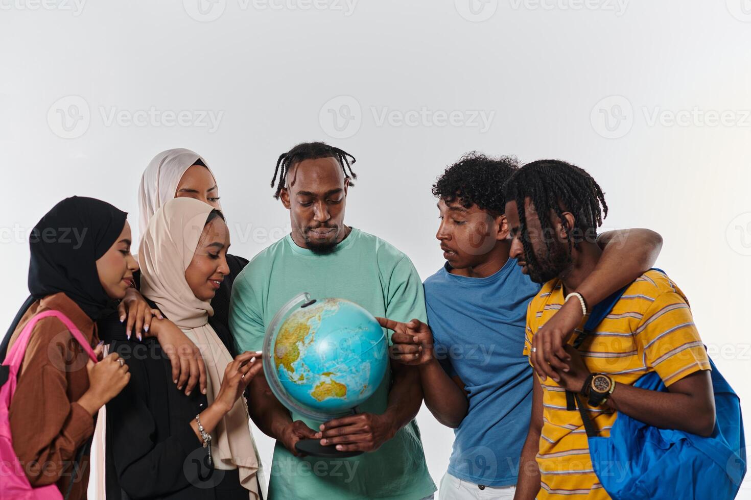 A diverse group of students is gathered around a globe, engrossed in exploration and study, their vibrant energy captured against a pristine white background, symbolizing unity and curiosity in their photo