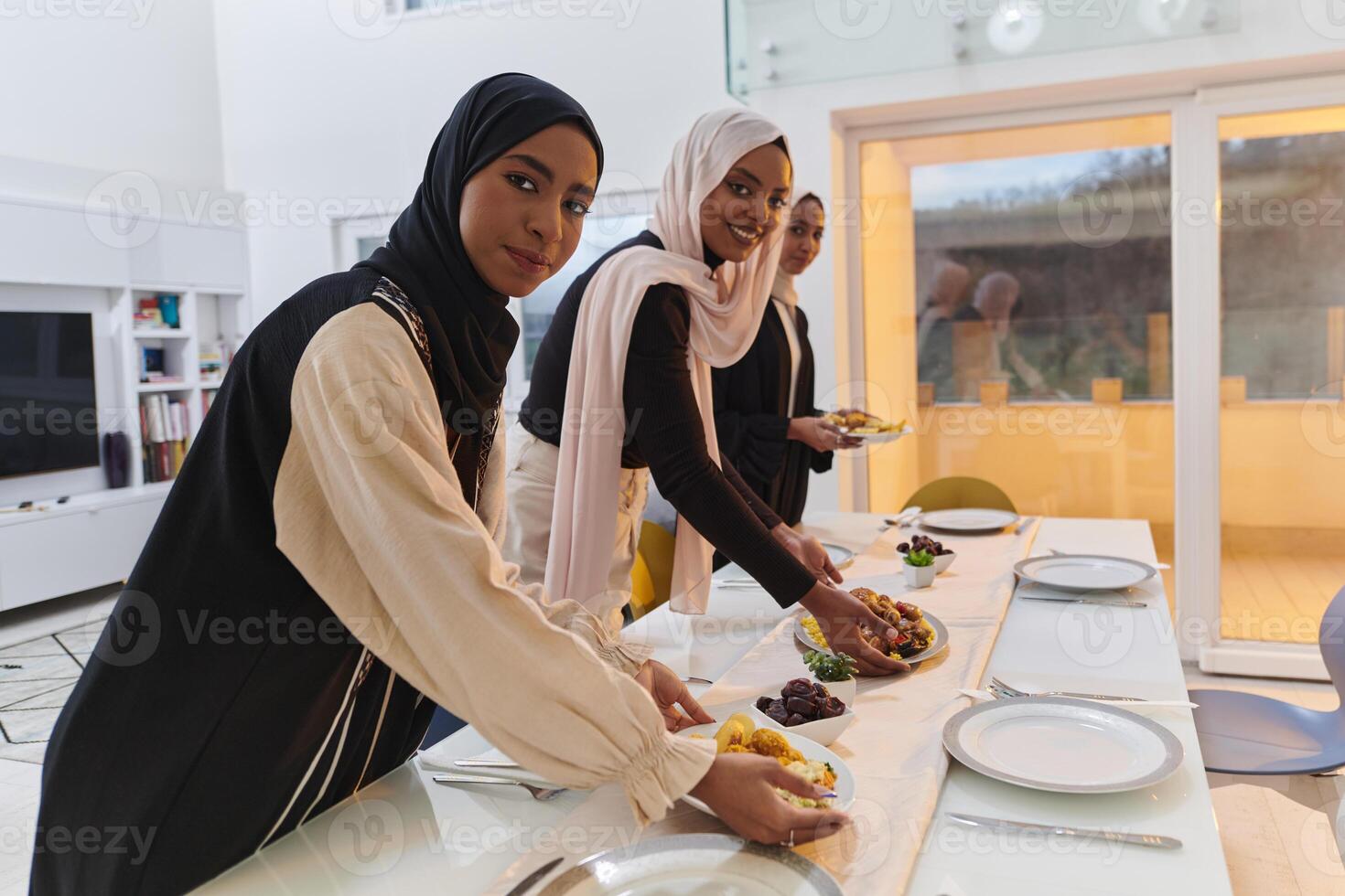 Group of young Arab women come together to lovingly prepare an iftar table during the sacred Muslim month of Ramadan, embodying the essence of communal unity, cultural tradition, and joyous photo
