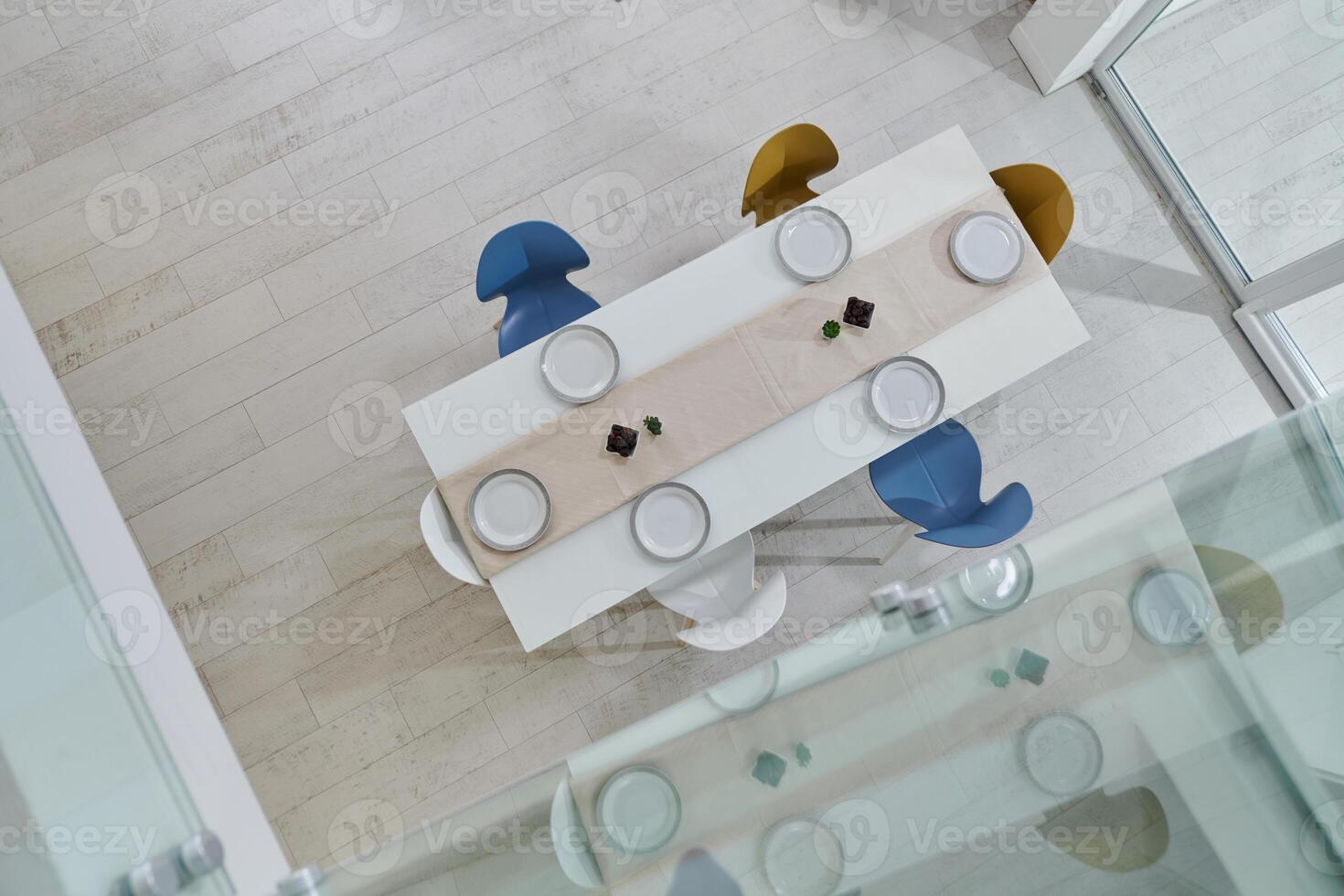A meticulously decorated empty table graces the modern home, radiating contemporary elegance, tasteful minimalism, and an inviting ambiance that reflects the sophisticated lifestyle of its inhabitants photo