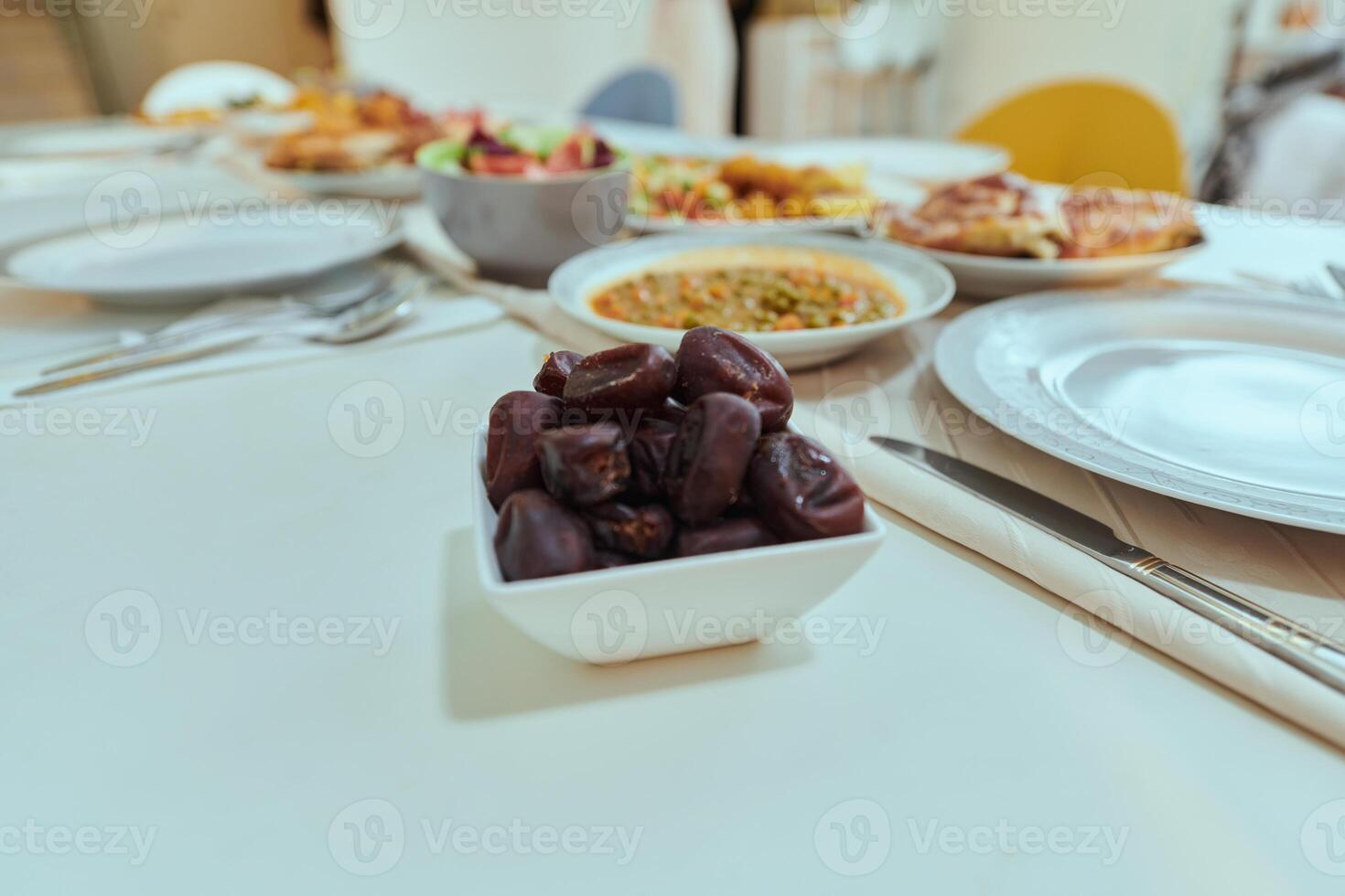 A picturesque array of dates and diverse, delectable dishes adorns the table, creating a sumptuous feast ready for the Iftar meal during the sacred month of Ramadan, embodying a rich tapestry of photo