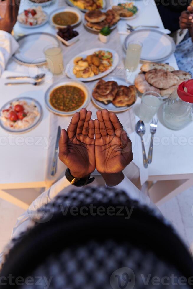 In the sacred month of Ramadan, a diverse Muslim family comes together in spiritual unity, fervently praying to God before breaking their fast, capturing a moment of collective devotion, cultural photo