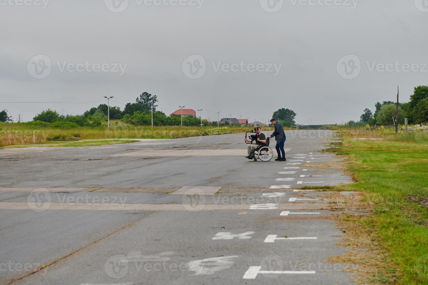 A team of videographers utilizes modern filming equipment while incorporating innovative accessibility tools, including the use of wheelchairs as aids, showcasing a creative and inclusive approach to photo