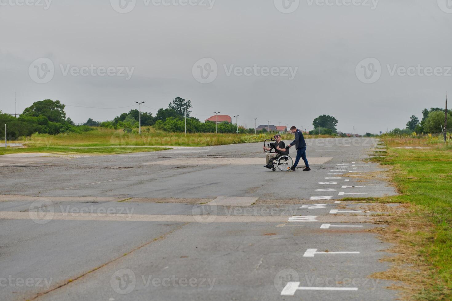 A team of videographers utilizes modern filming equipment while incorporating innovative accessibility tools, including the use of wheelchairs as aids, showcasing a creative and inclusive approach to photo